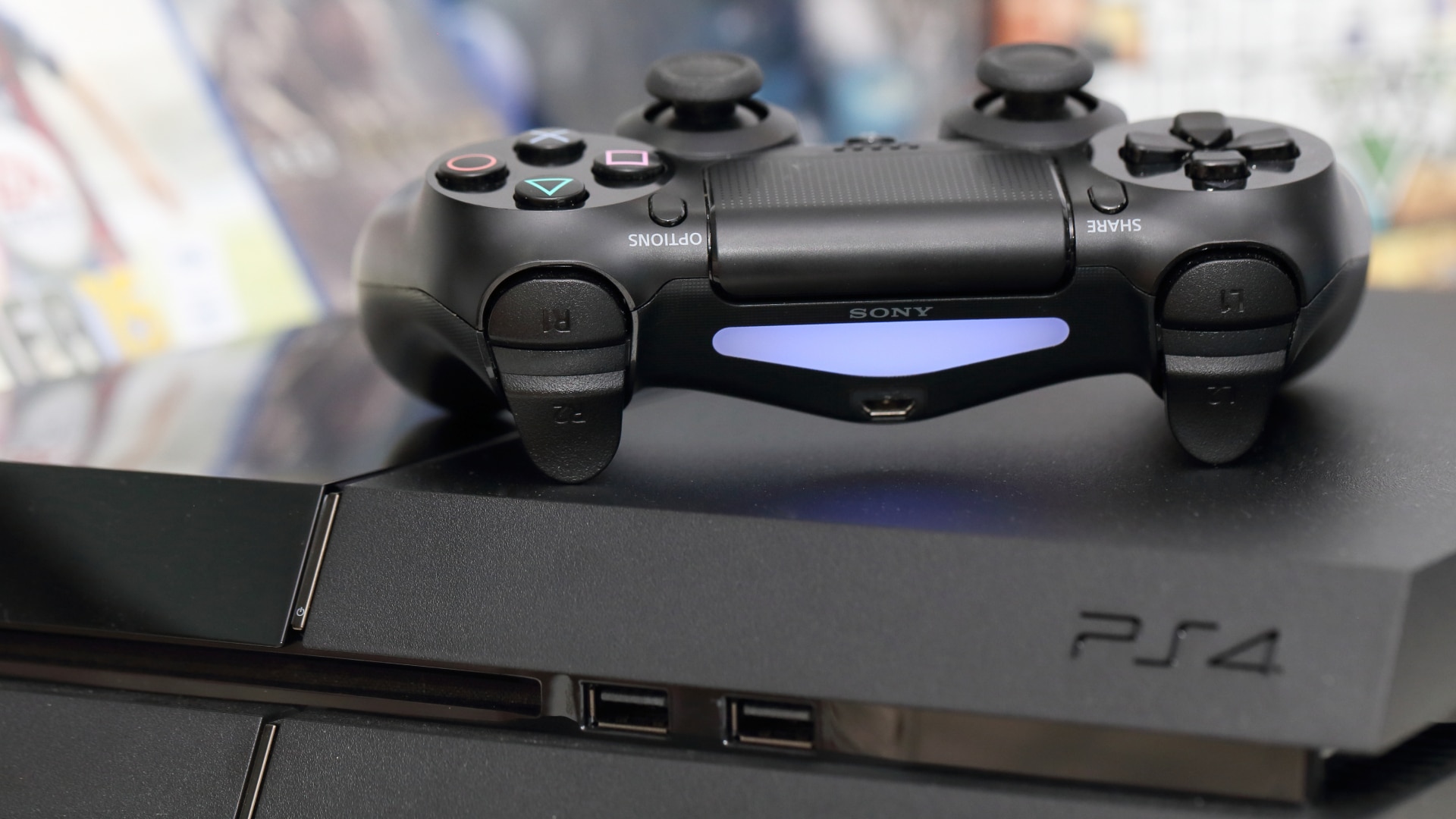 Manette DualShock 4 posée sur le dessus d'une console PS4